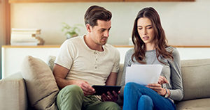 young couple researching life insurance pre-existing condition